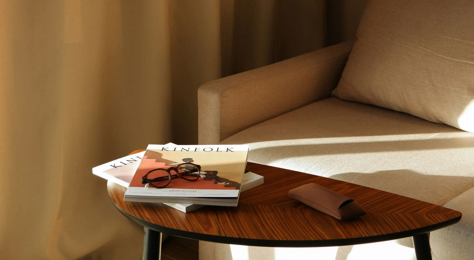 a living room with a couch and books on a table