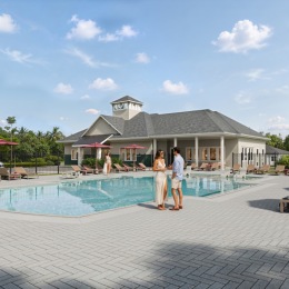 a couple standing by a pool